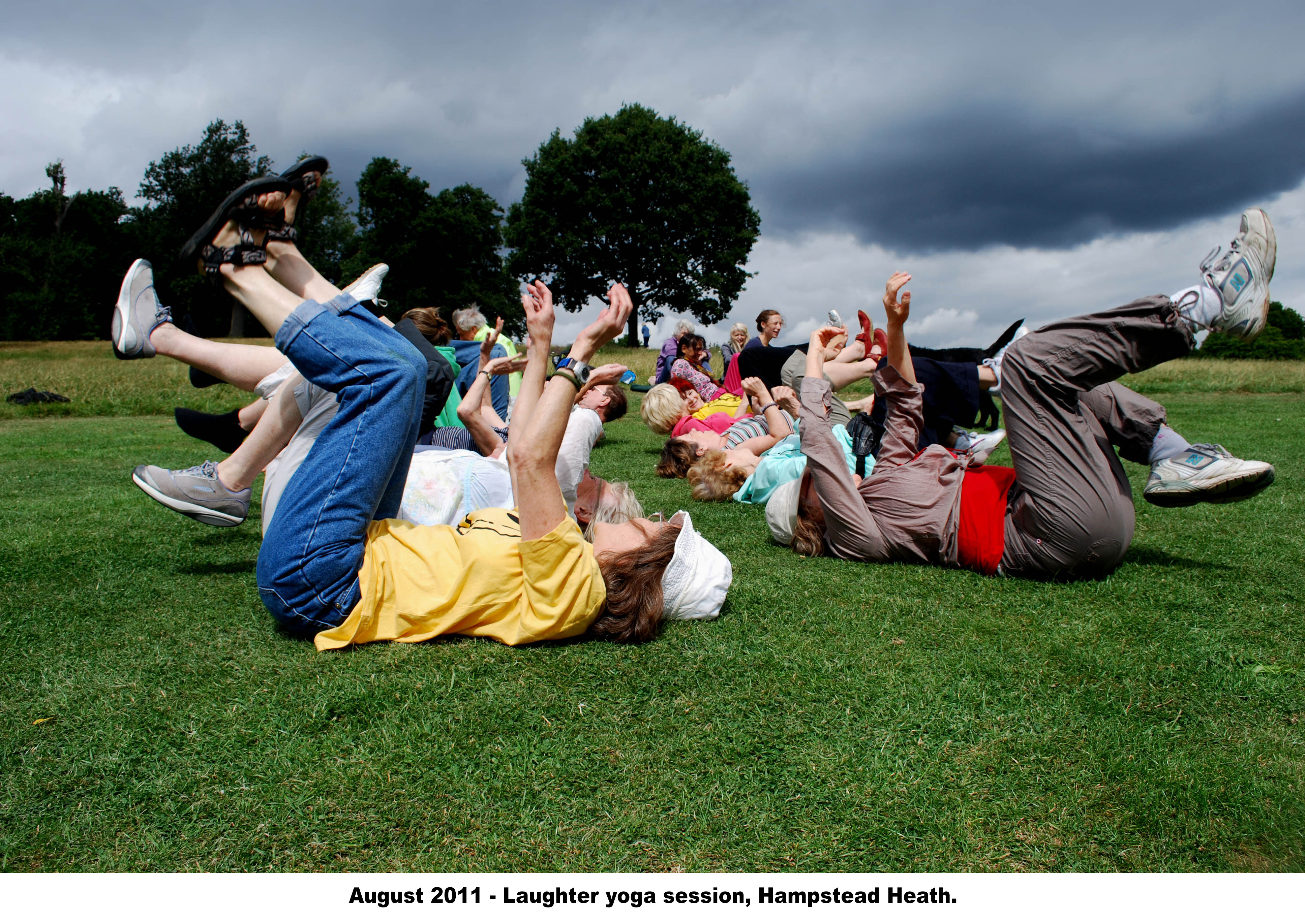 people on backs doing laughter yoga