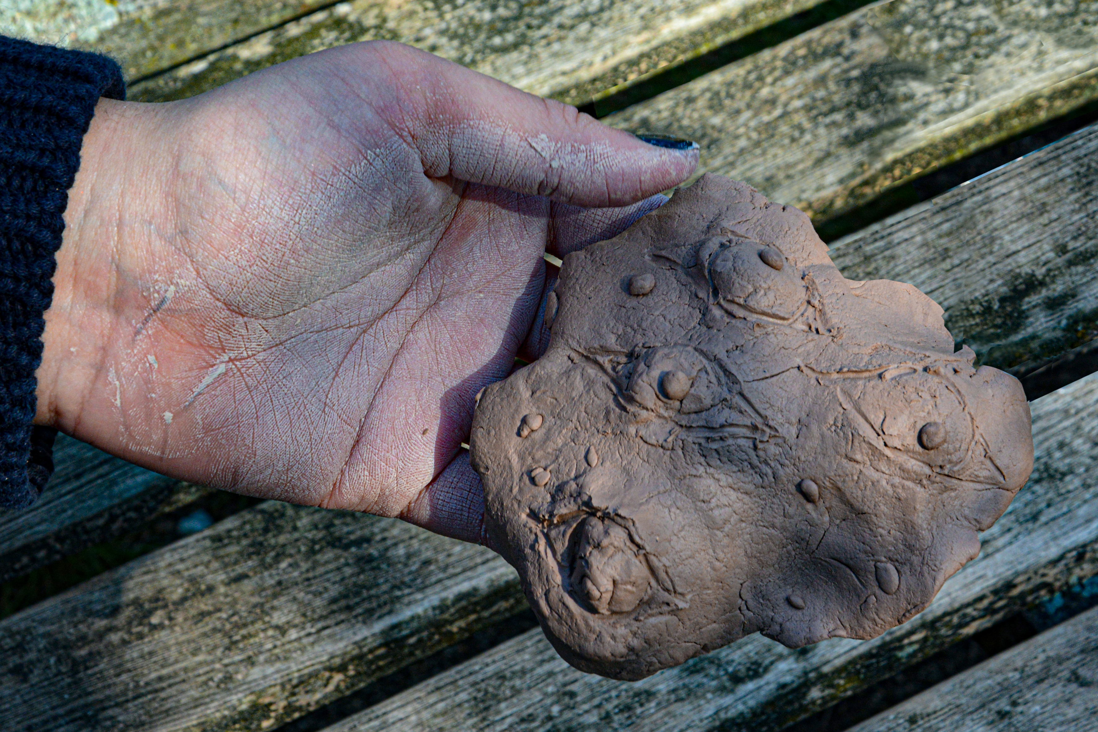 Hand displaying clay artwork