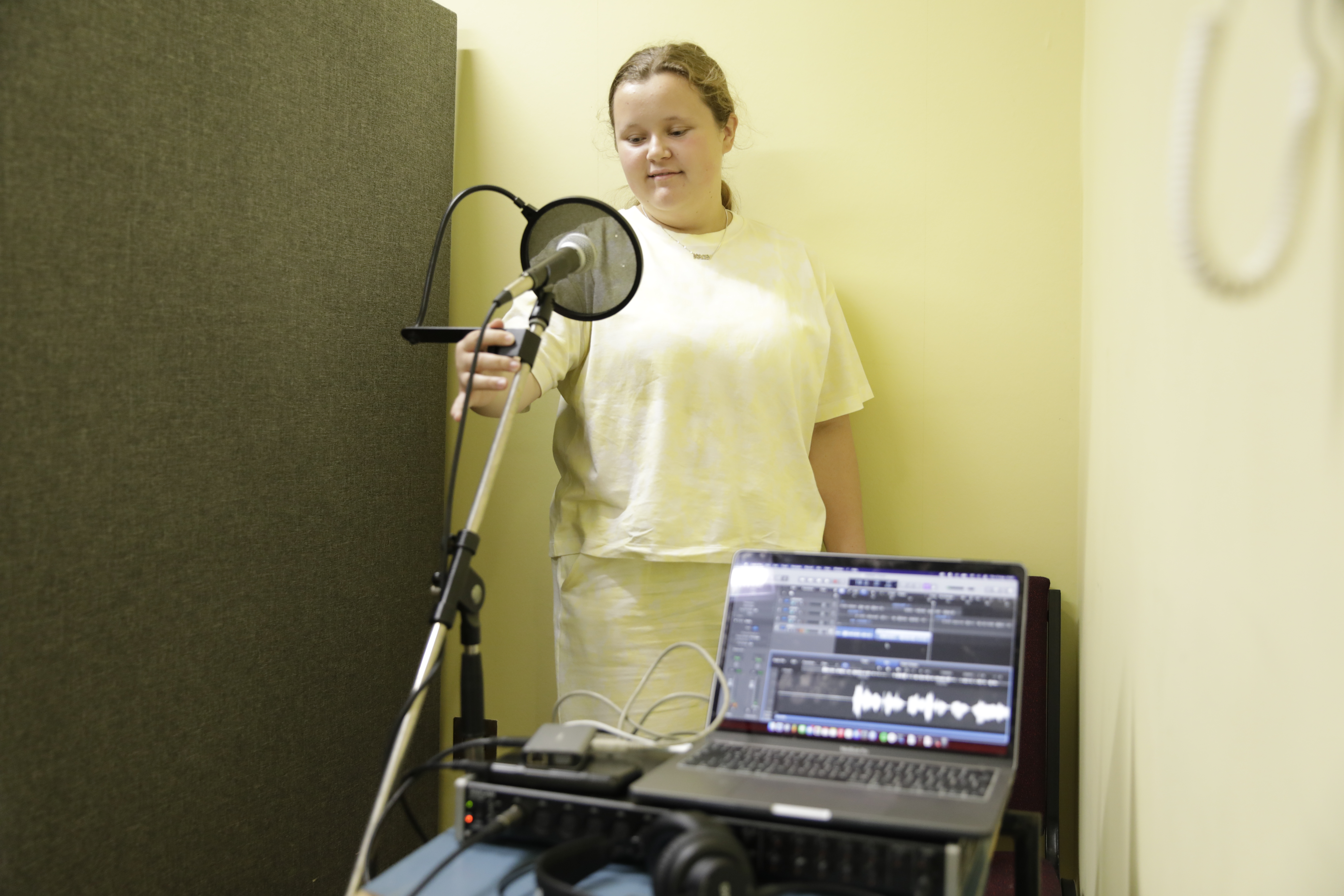 A young person recording vocals