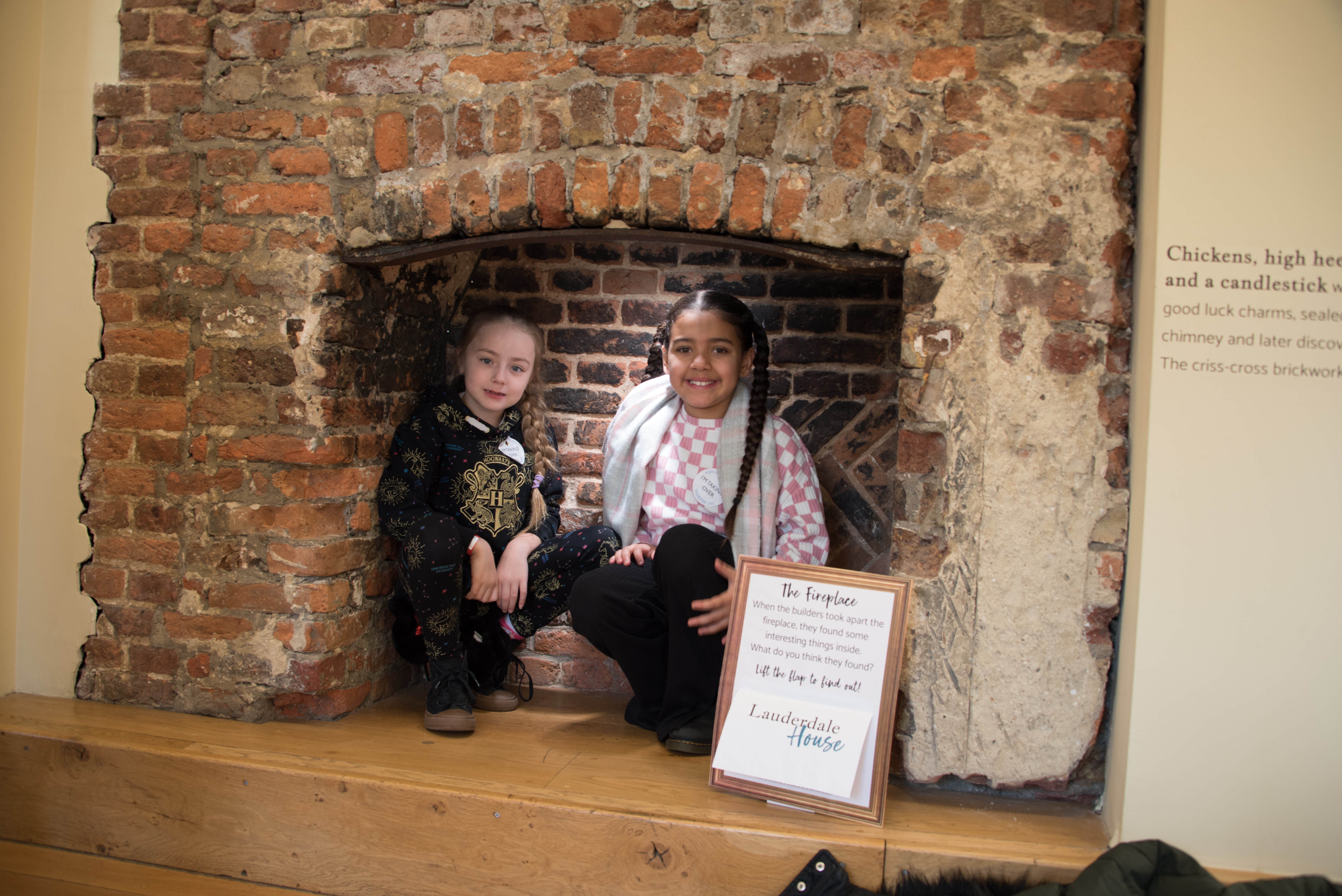 students sitting in the old fireplace