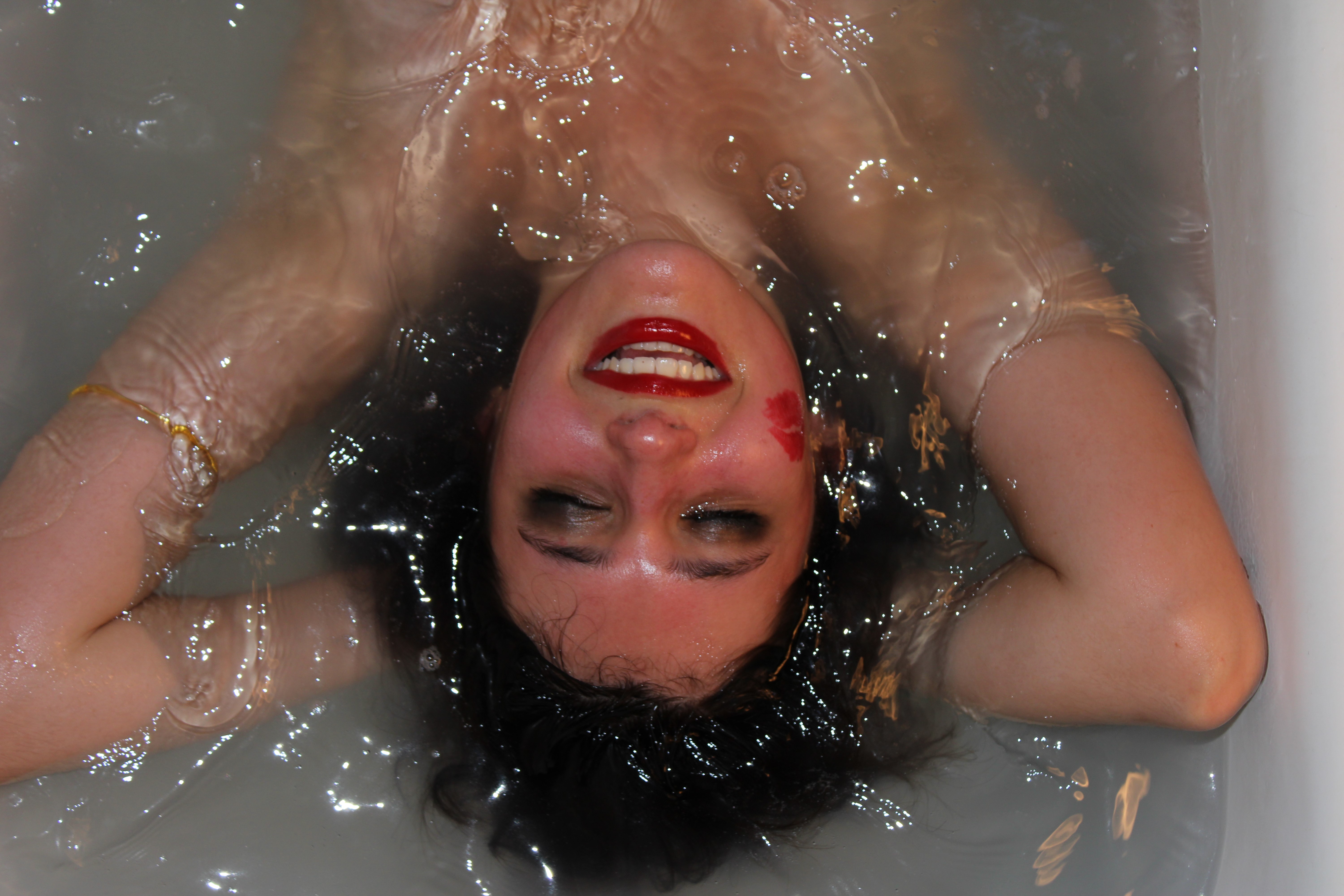 a photograph of a girl in bubbly water