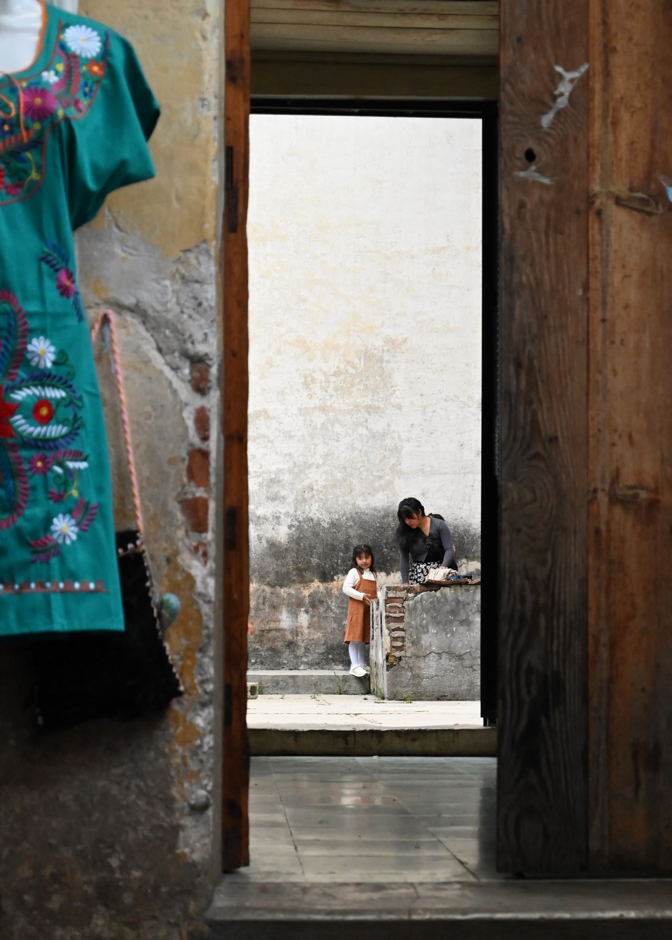Image of an open doorway, showing a mom and daughter