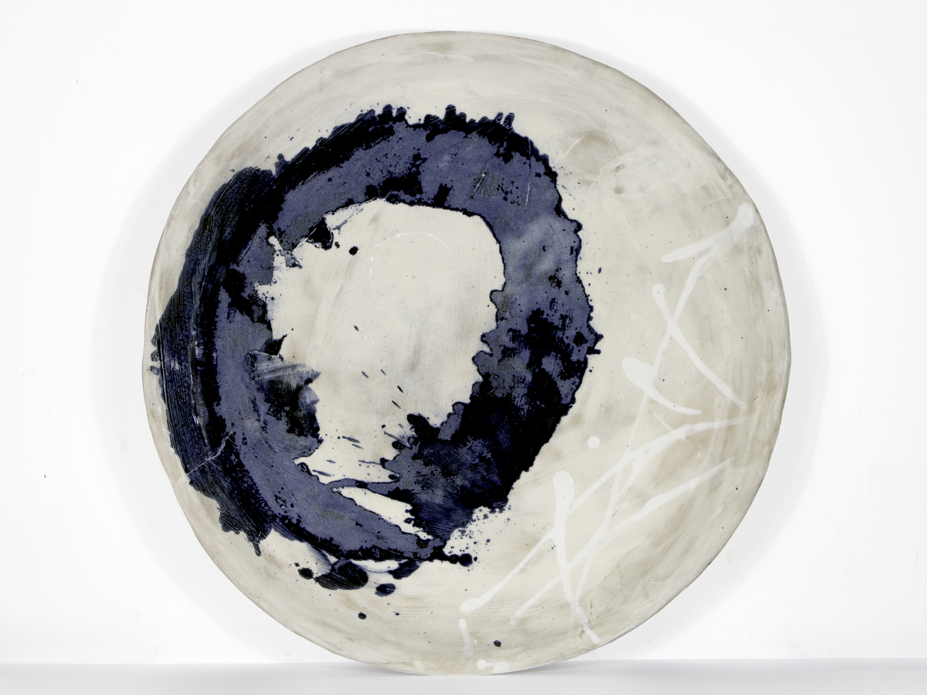 Circular artwork with a navy circle with the piece