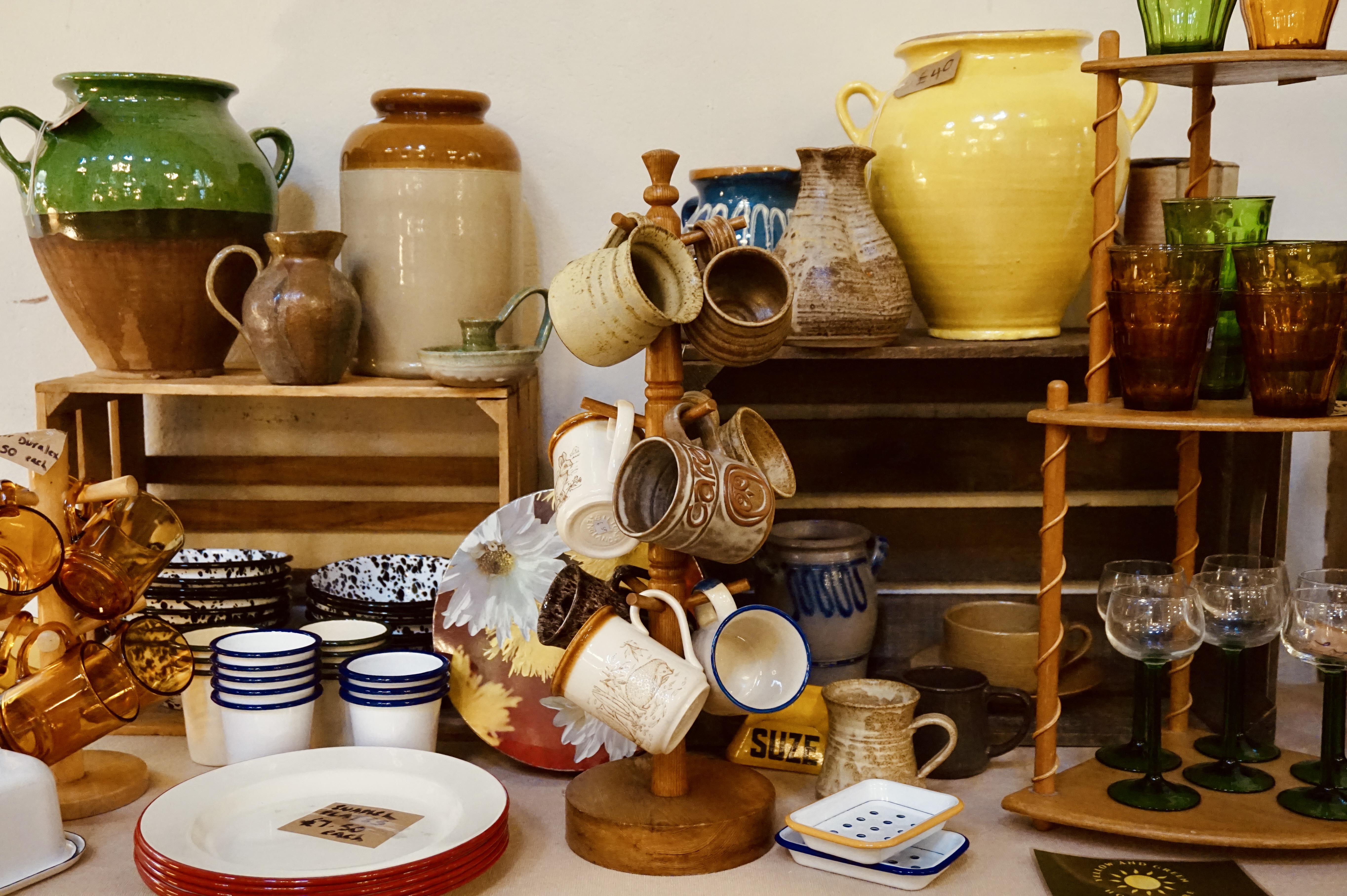mugs and plates on a flea market table