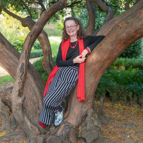Katherine leaning against a tree
