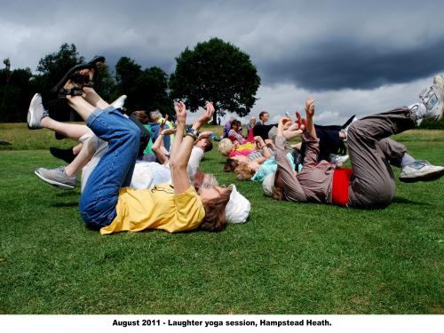 people lying on their backs with their feet in the air doing laughter yoga