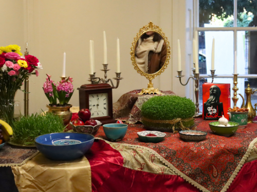photograph of Councillor Camron Aref-Adib and of a Haft-sin display